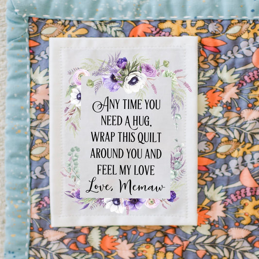 Anytime you need A hug, wrap this quilt around you and feel my love. Personalized quilt labels in a purple floral frame on cotton or polyester - Jammin Threads