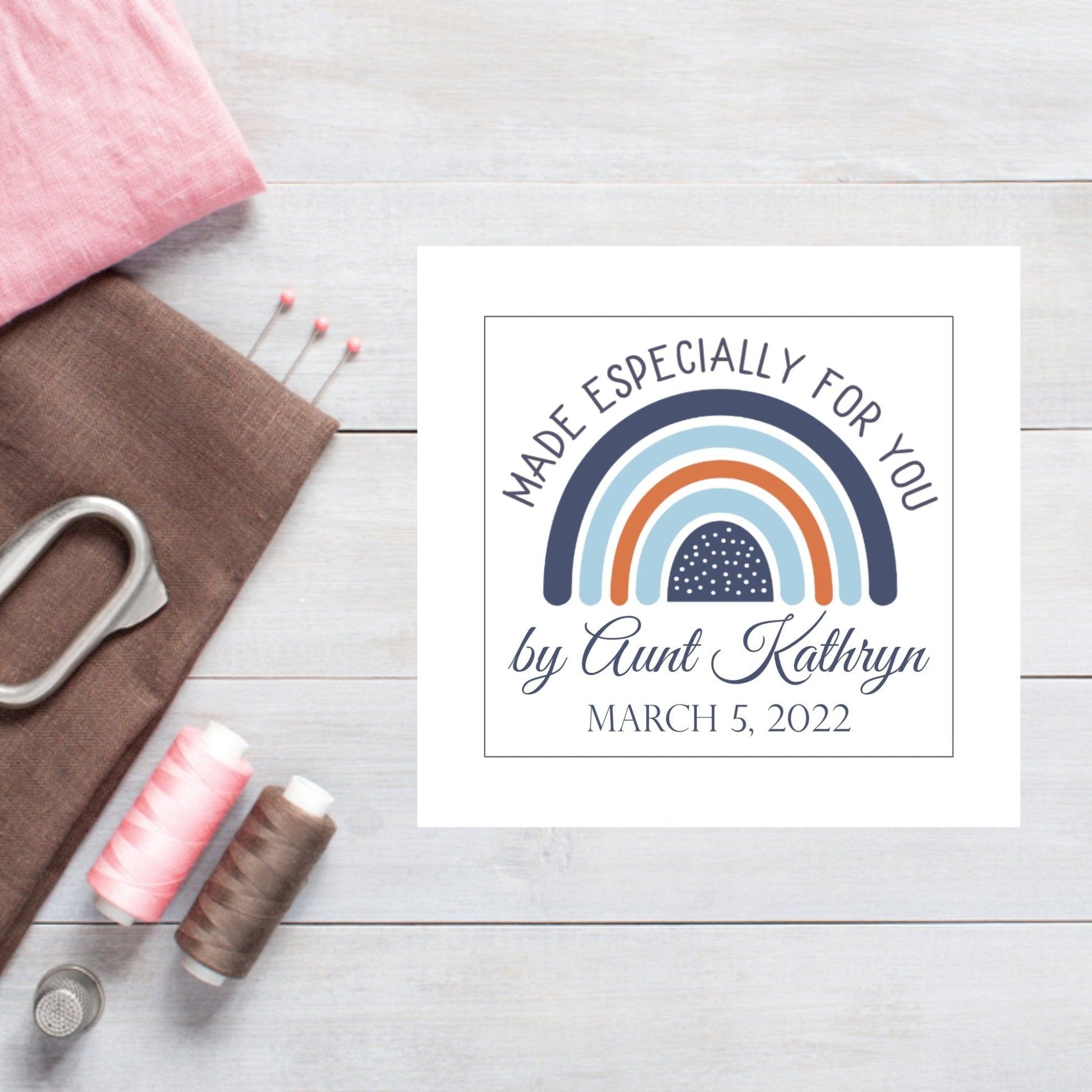 Custom baby quilt label with a rainbow in shades of blue - Jammin Threads