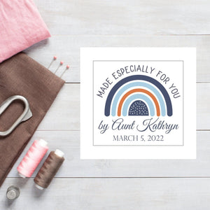 Custom baby quilt label with a rainbow in shades of blue- Jammin Threads
