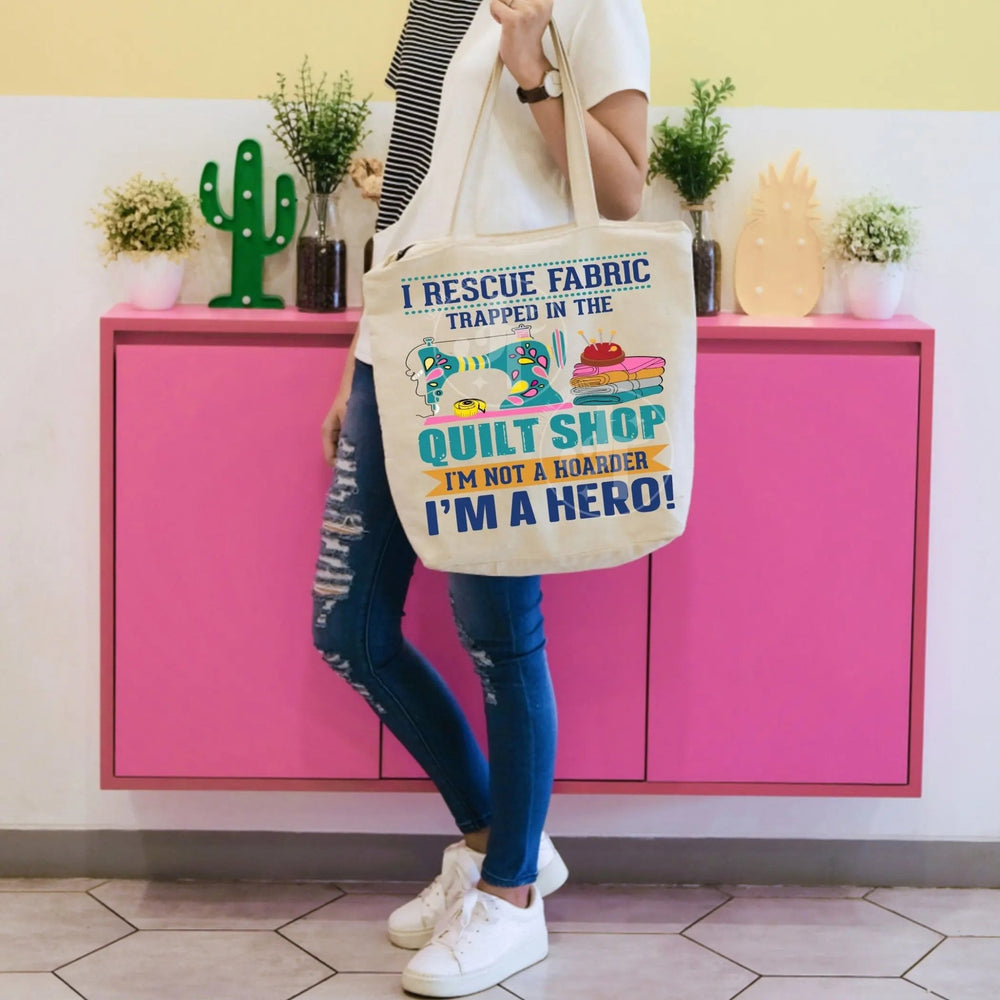 Funny quilter tote bag with sewing machine design and quote “I rescue fabric trapped in the quilt shop I'm not a hoarder I'm a hero” with personalized name on back