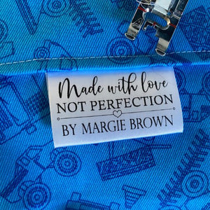 Personalized satin quilt tag made with love not perfection with custom maker name sewn into quilt seam