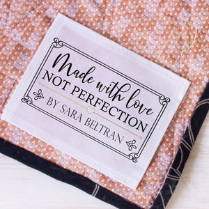 Personalized made with love not perfection quilt label sewn onto handmade quilt backing