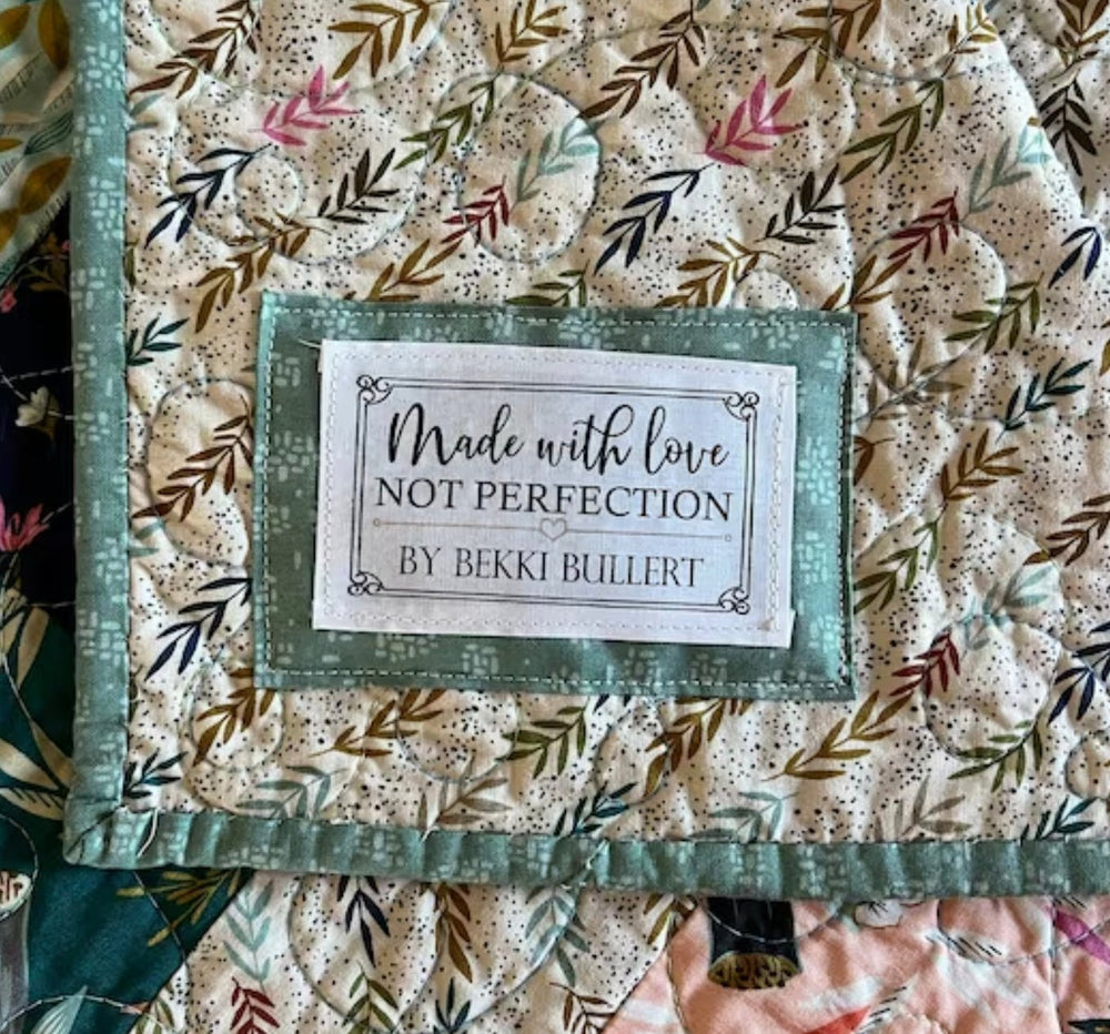 Personalized made with love not perfection quilt label sewn onto handmade quilt backing